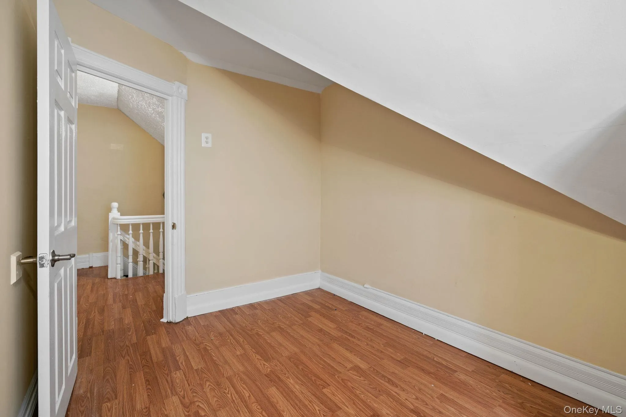 Additional living space featuring wood finished floors and vaulted ceiling Additional living space featuring wood finished floors and vaulted ceiling