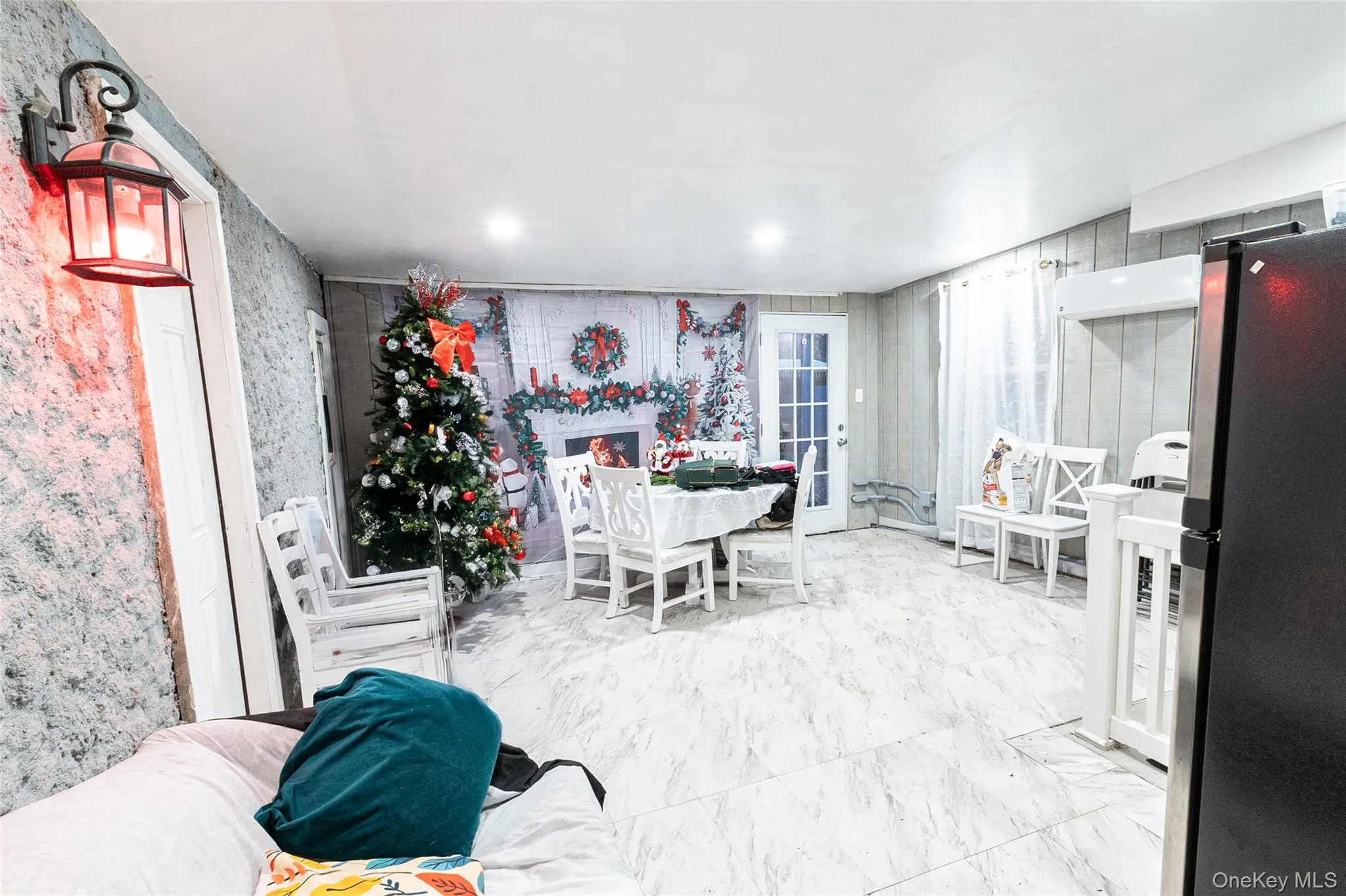 Dining room featuring marble finish flooring and wallpapered walls Dining room featuring marble finish flooring and wallpapered walls