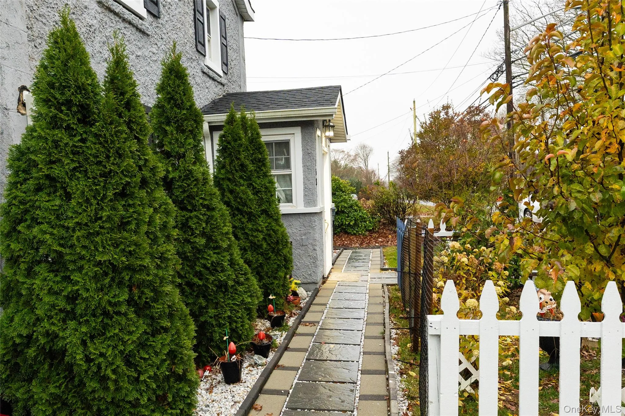 View of home's exterior with stucco siding and a shingled roof View of home's exterior with stucco siding and a shingled roof
