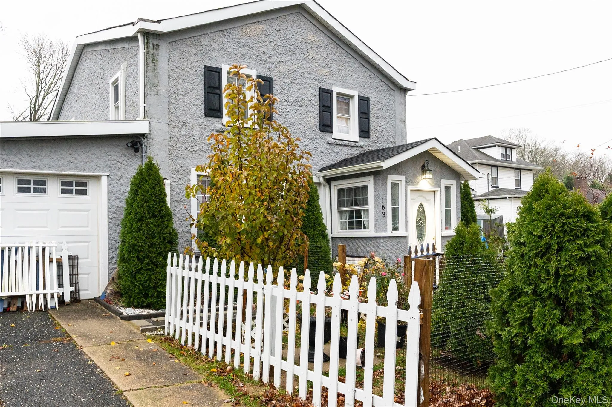 View of front of home featuring a fenced front yard and stucco siding View of front of home featuring a fenced front yard and stucco siding