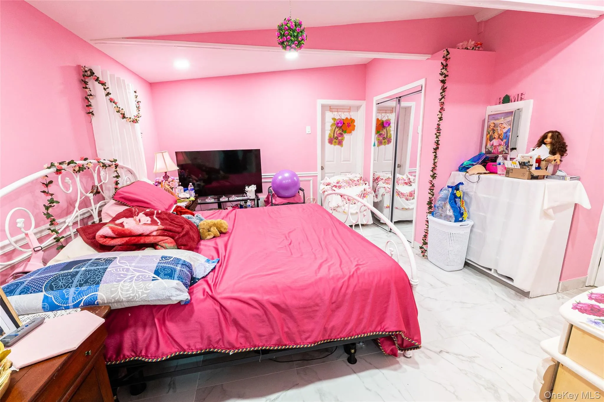 Bedroom with marble look tiles and a closet Bedroom with marble look tiles and a closet