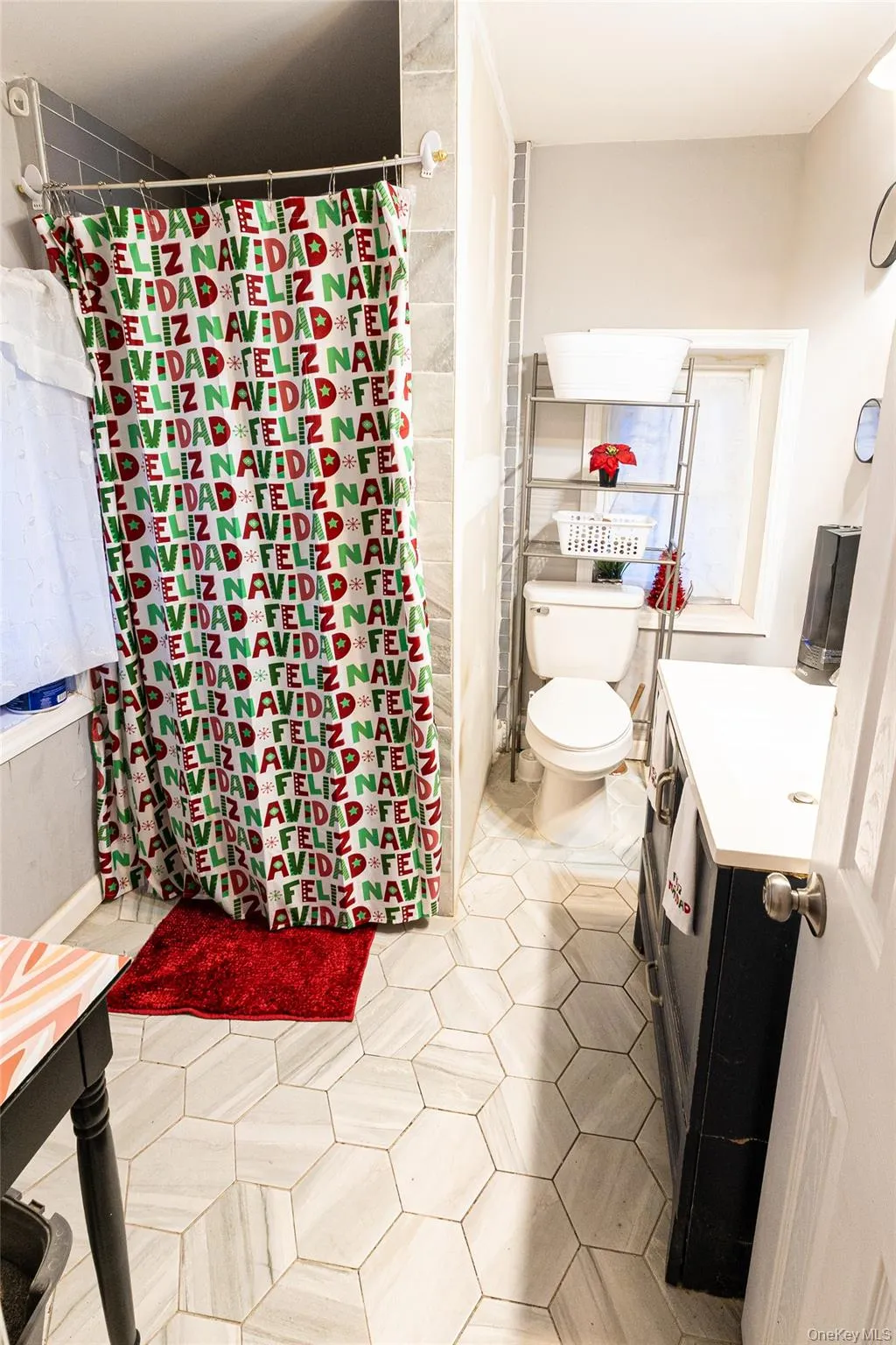 Bathroom featuring vanity, a shower with shower curtain, and light tile patterned floors Bathroom featuring vanity, a shower with shower curtain, and light tile patterned floors
