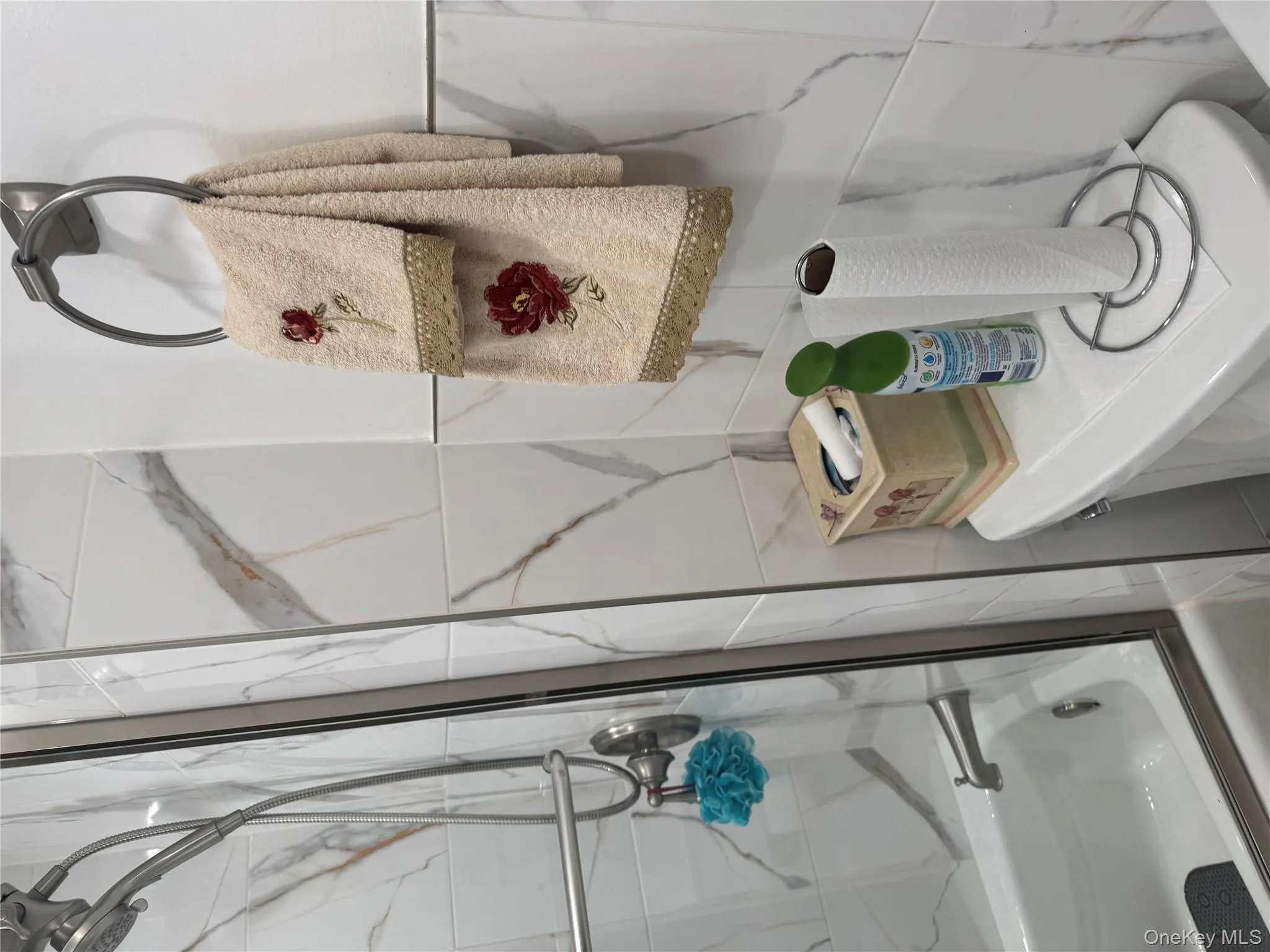 Bathroom with bath / shower combo with glass door and tile walls Bathroom with bath / shower combo with glass door and tile walls