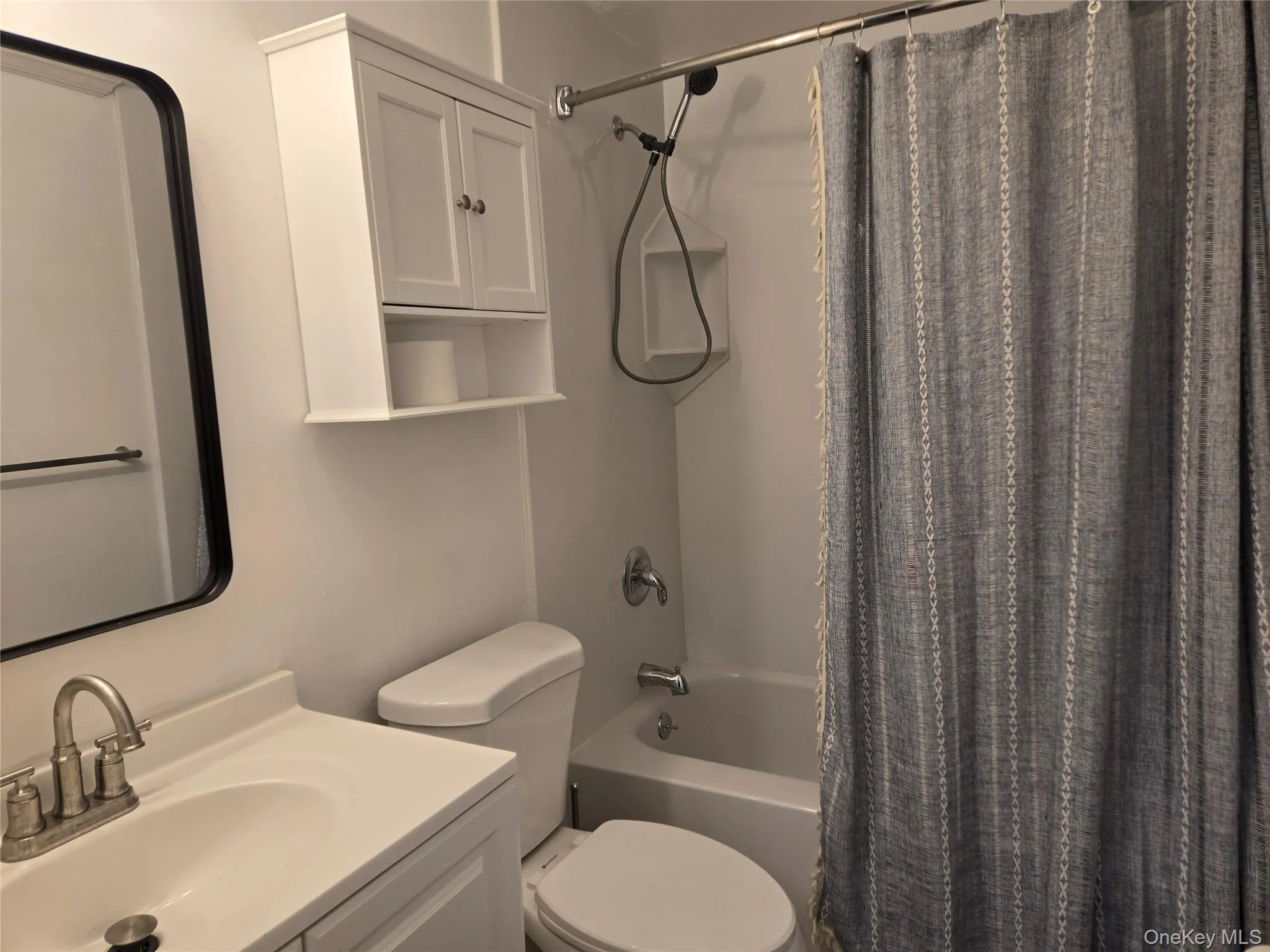 Bathroom with shower / tub combo with curtain and vanity Bathroom with shower / tub combo with curtain and vanity