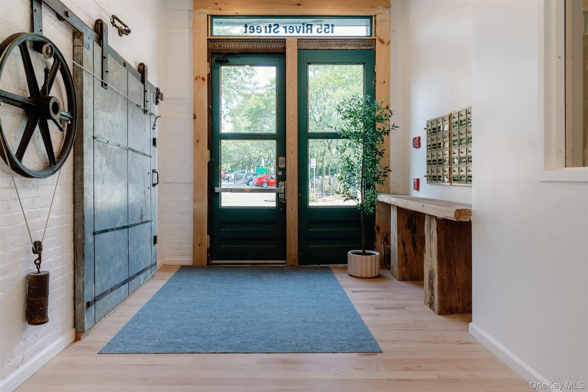 Doorway to outside with a barn door and wood finished floors Doorway to outside with a barn door and wood finished floors