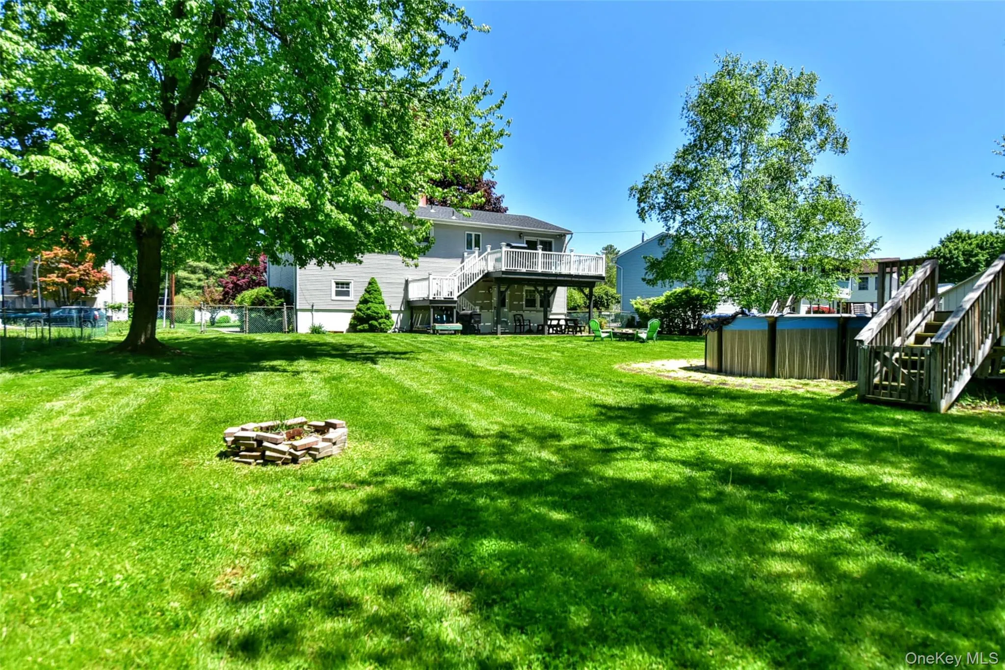 This spacious backyard has flat property enclosed by a chain linked fence This spacious backyard has flat property enclosed by a chain linked fence