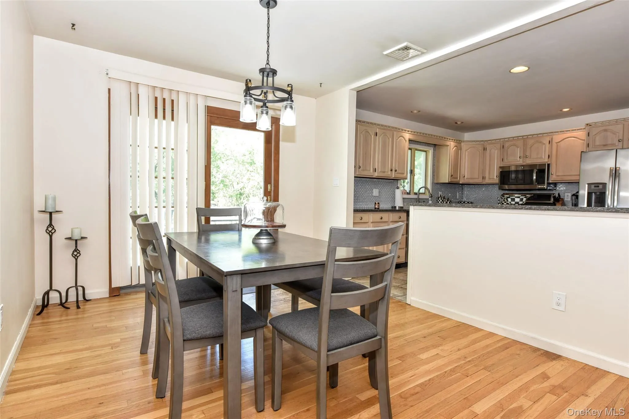 The dining area is sun drenched through glass sliding doors and light- colored walls The dining area is sun drenched through glass sliding doors and light- colored walls