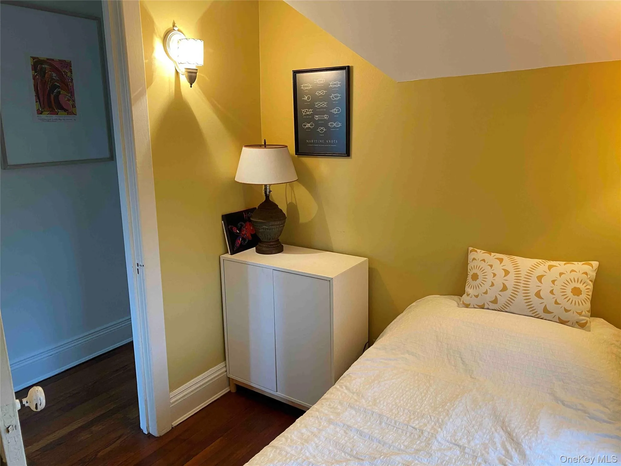 Bedroom featuring baseboards and dark wood-style floors Bedroom featuring baseboards and dark wood-style floors