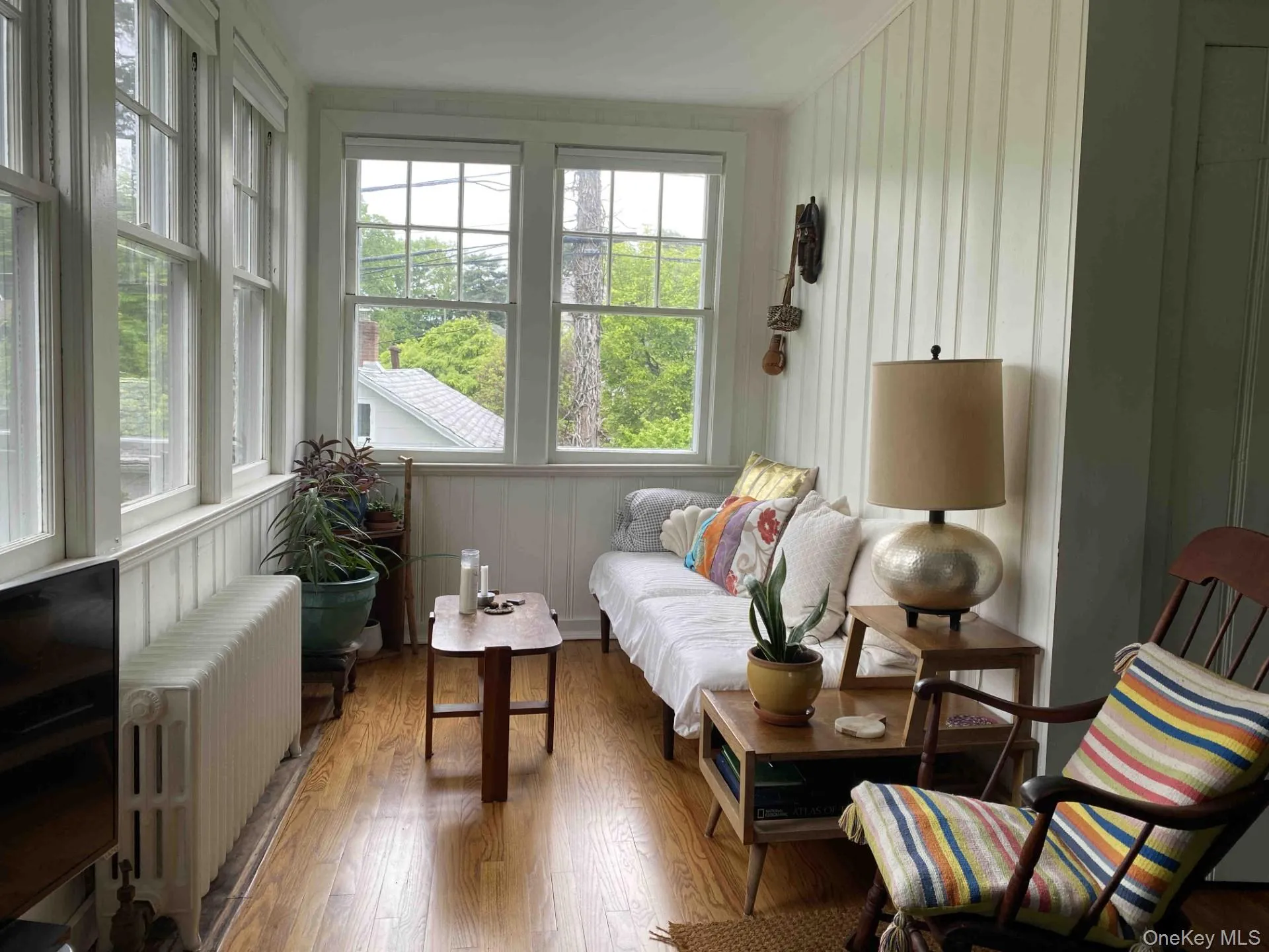 Sunroom / solarium with radiator heating unit and hardwood / wood-style flooring Sunroom / solarium with radiator heating unit and hardwood / wood-style flooring