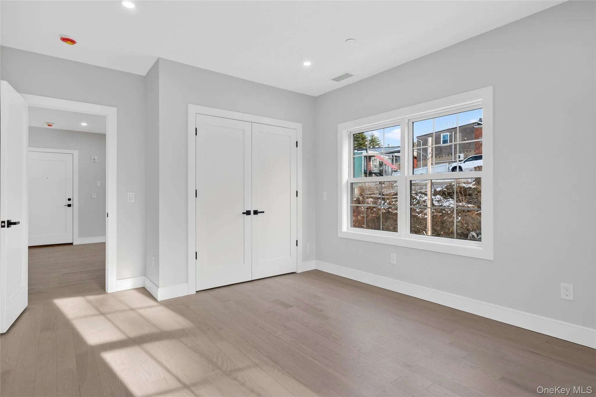 Unfurnished bedroom featuring light wood-style floors, recessed lighting, and a closet Unfurnished bedroom featuring light wood-style floors, recessed lighting, and a closet