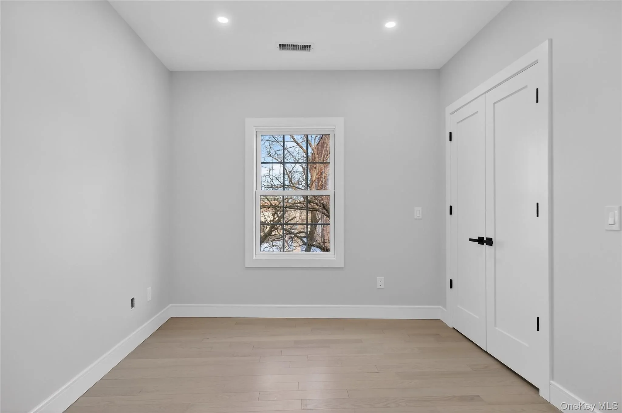 Spare room with light wood finished floors and recessed lighting Spare room with light wood finished floors and recessed lighting