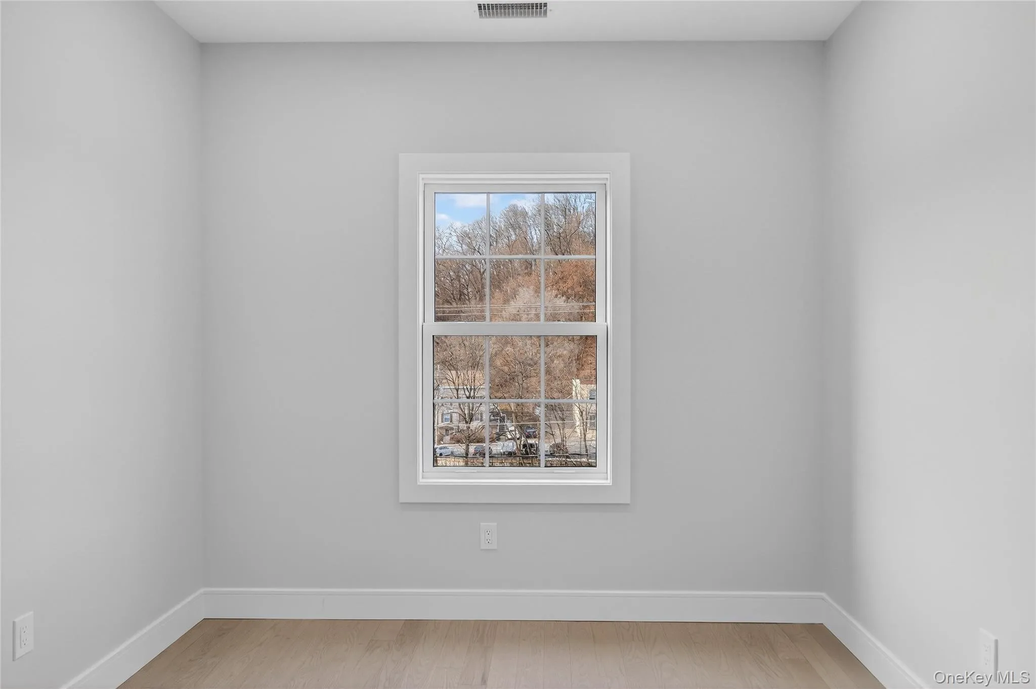 Spare room featuring baseboards and light wood finished floors Spare room featuring baseboards and light wood finished floors