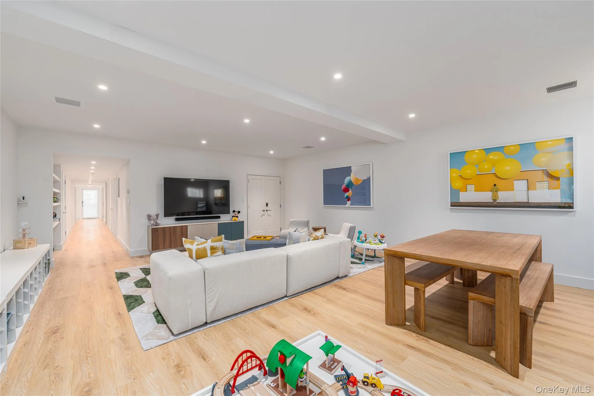 Living area featuring light wood-style flooring and recessed lighting Living area featuring light wood-style flooring and recessed lighting