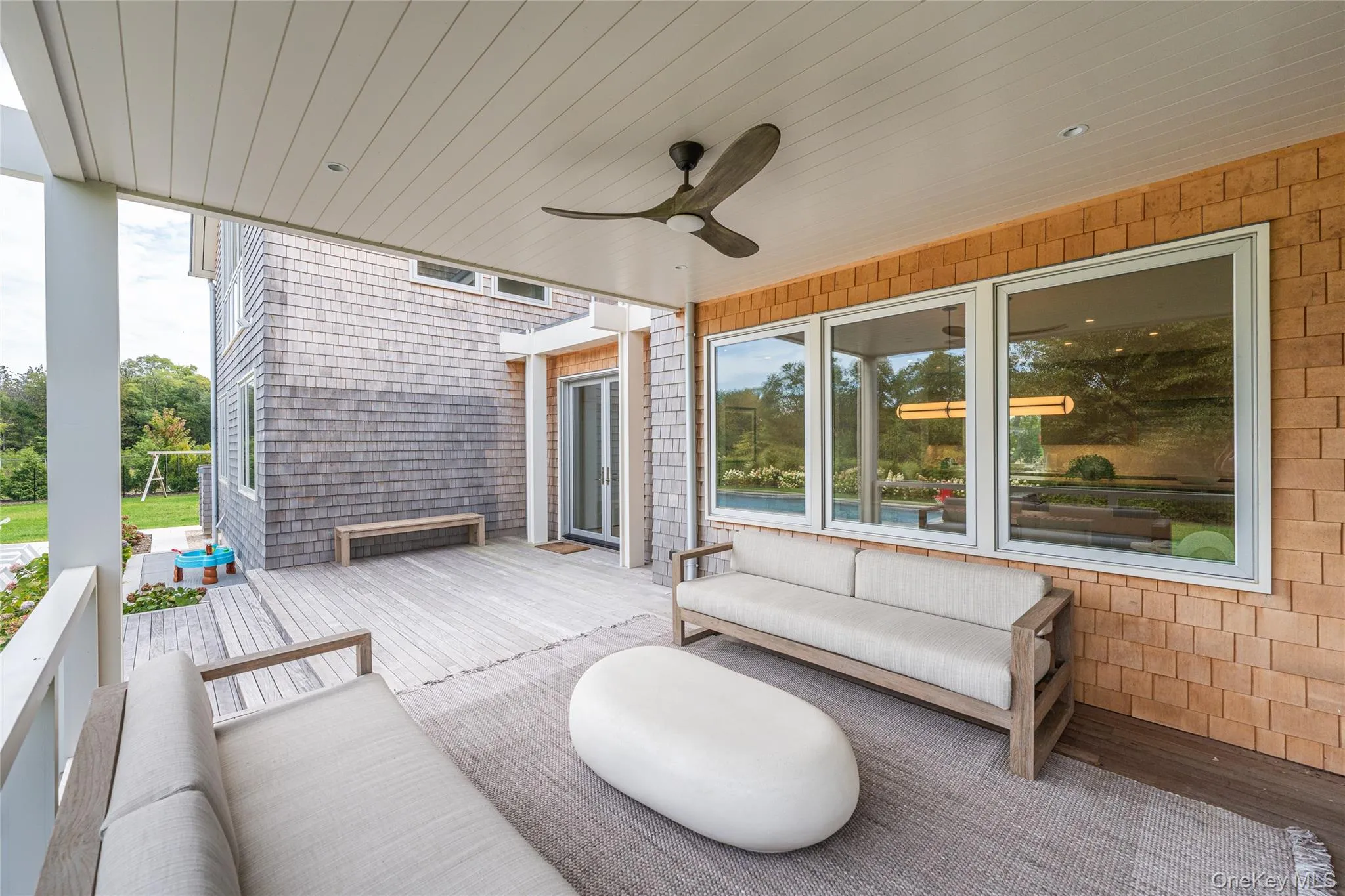 Wooden deck featuring a ceiling fan and an outdoor living space Wooden deck featuring a ceiling fan and an outdoor living space