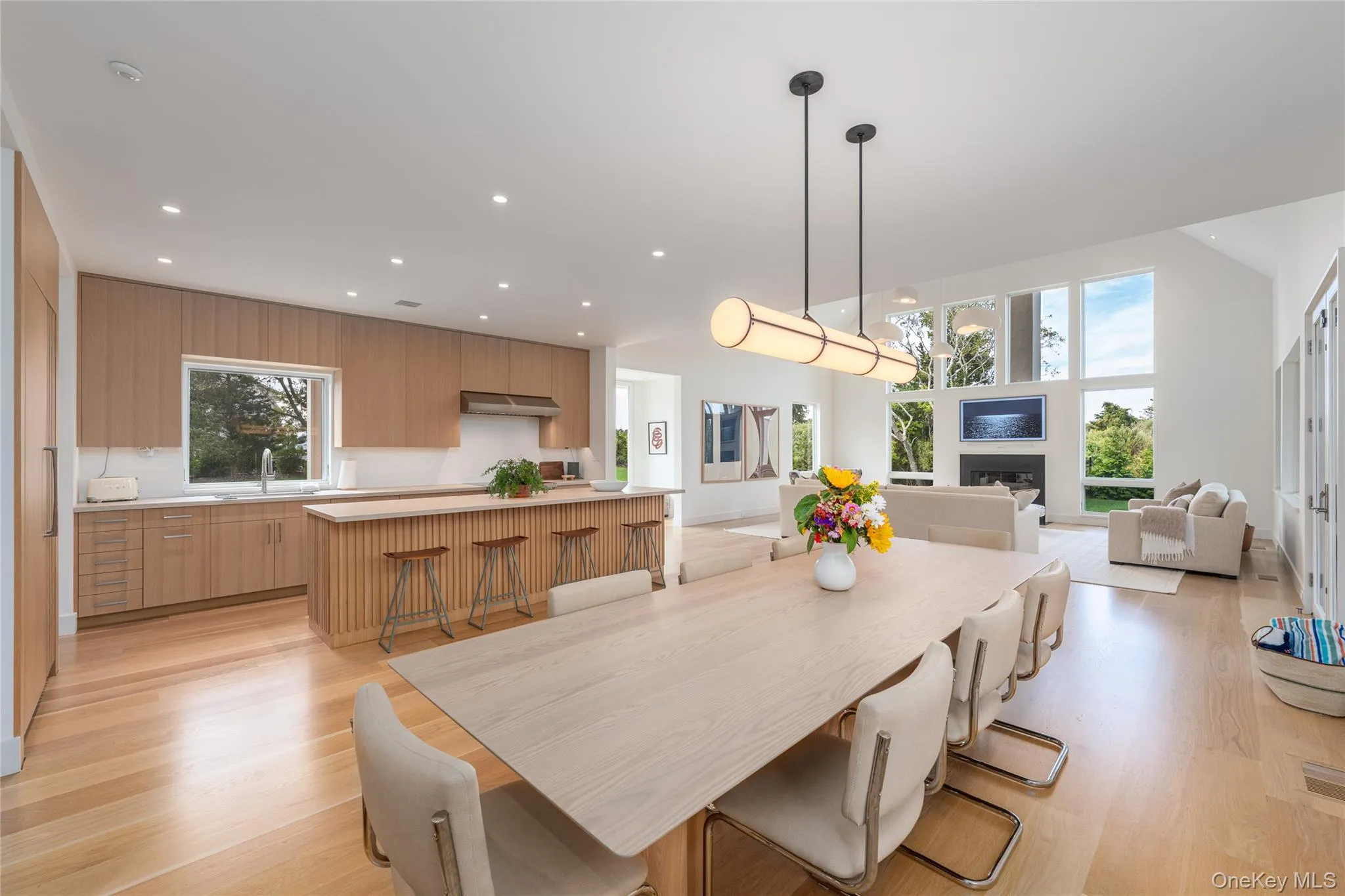 Dining room with light wood-type flooring, recessed lighting, and a fireplace Dining room with light wood-type flooring, recessed lighting, and a fireplace