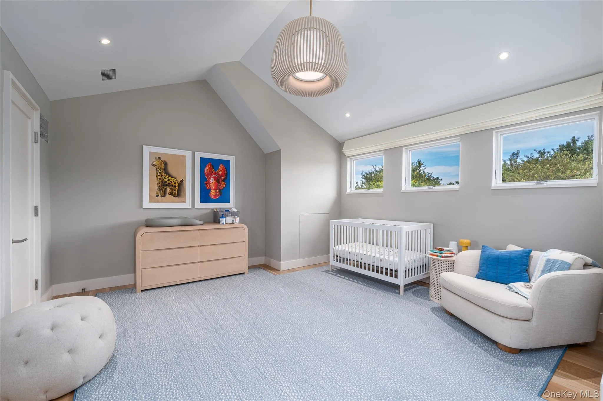 Bedroom with vaulted ceiling, a crib, and recessed lighting Bedroom with vaulted ceiling, a crib, and recessed lighting