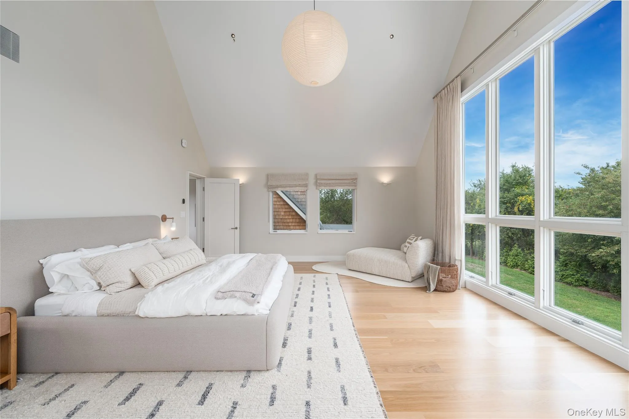 Bedroom with high vaulted ceiling and light wood-type flooring Bedroom with high vaulted ceiling and light wood-type flooring