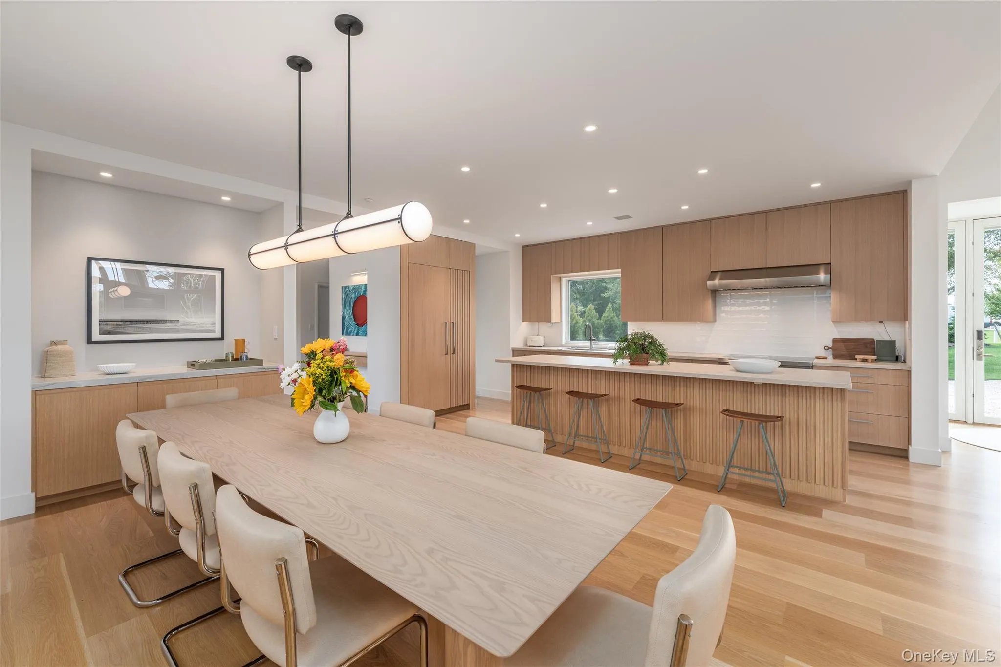 Dining space with light wood-type flooring and recessed lighting Dining space with light wood-type flooring and recessed lighting