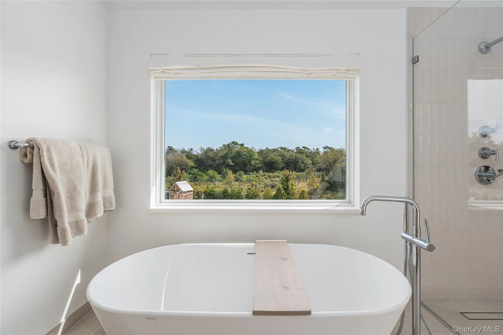 Bathroom featuring a freestanding bath, healthy amount of natural light, and a stall shower Bathroom featuring a freestanding bath, healthy amount of natural light, and a stall shower