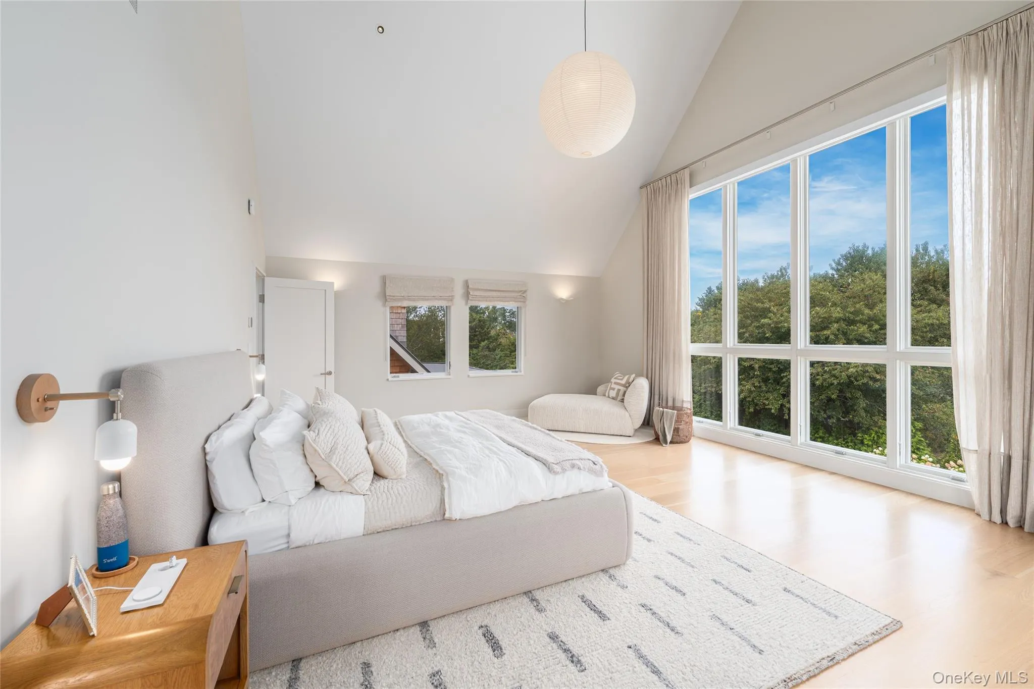 Bedroom with wood finished floors and high vaulted ceiling Bedroom with wood finished floors and high vaulted ceiling