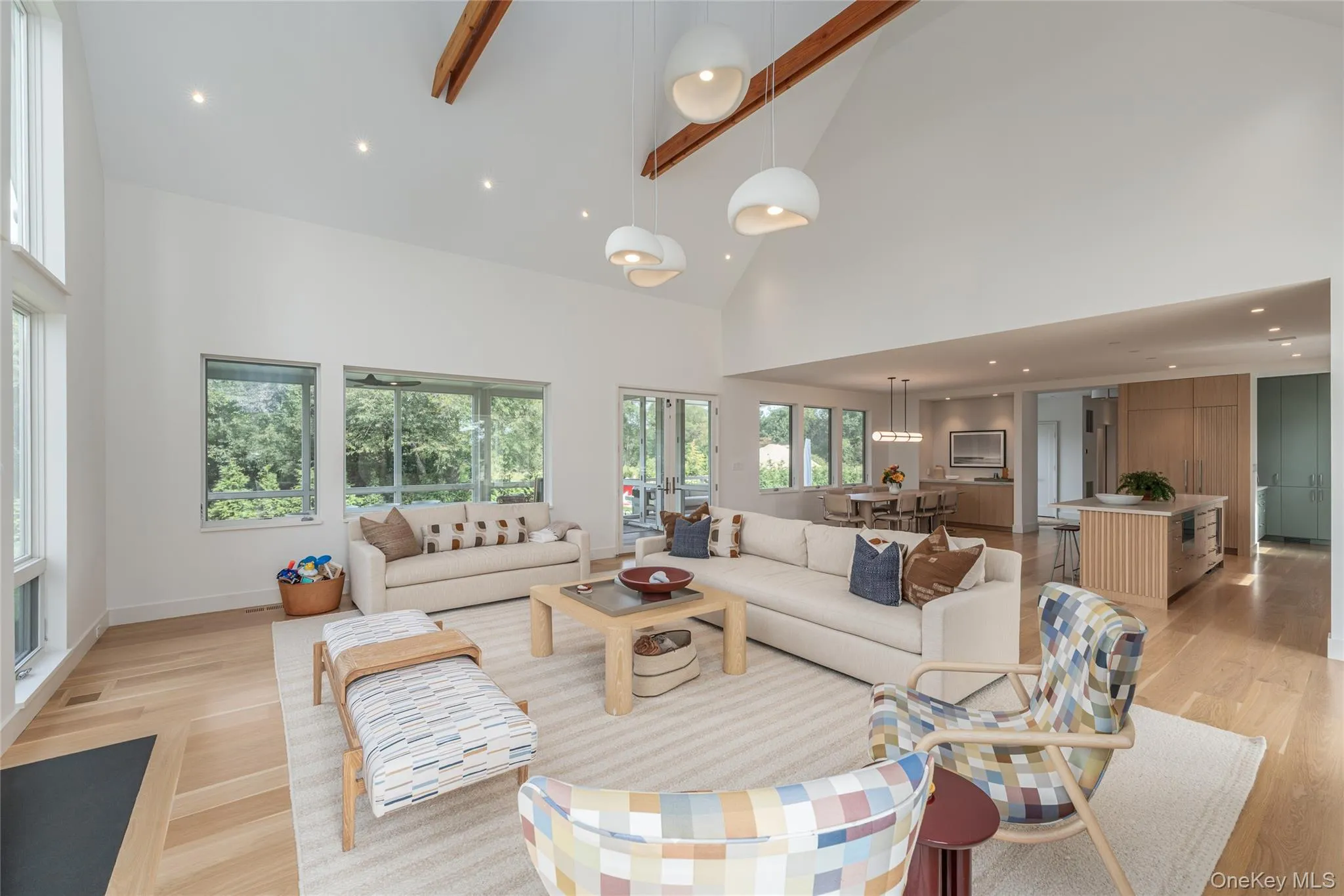 Living room with recessed lighting, beam ceiling, high vaulted ceiling, and light wood-style floors Living room with recessed lighting, beam ceiling, high vaulted ceiling, and light wood-style floors