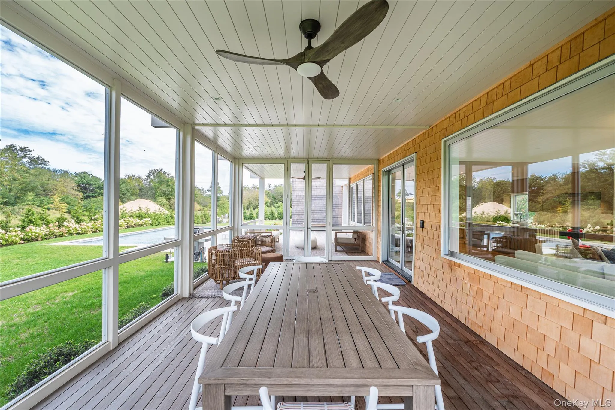 Sunroom with ceiling fan, healthy amount of natural light, and view of scattered trees Sunroom with ceiling fan, healthy amount of natural light, and view of scattered trees