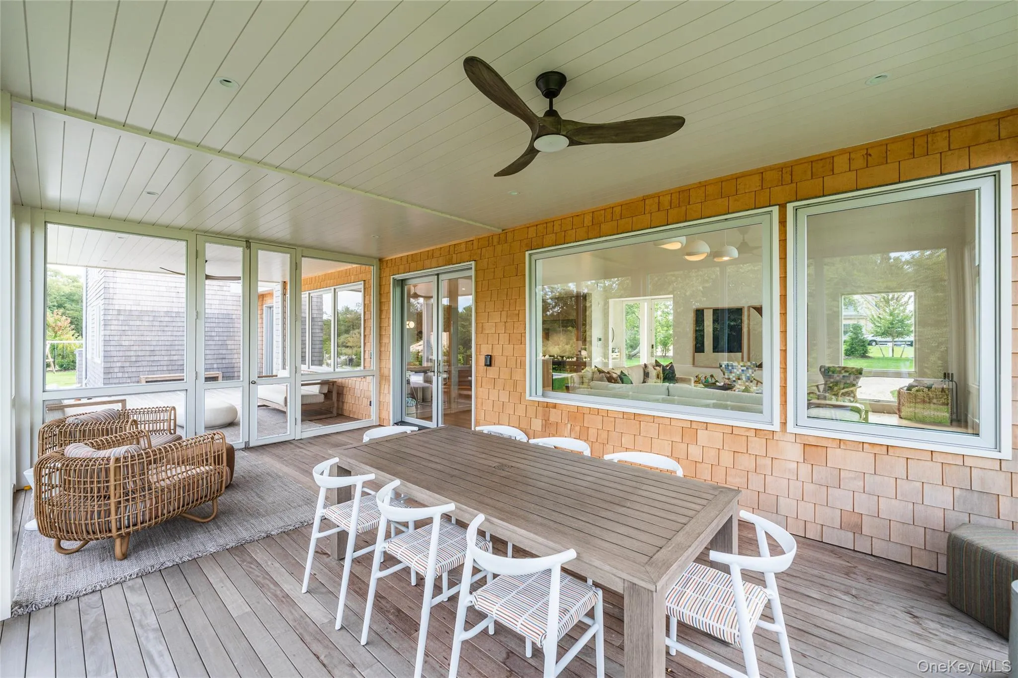 Sunroom / solarium with ceiling fan and outdoor dining space Sunroom / solarium with ceiling fan and outdoor dining space