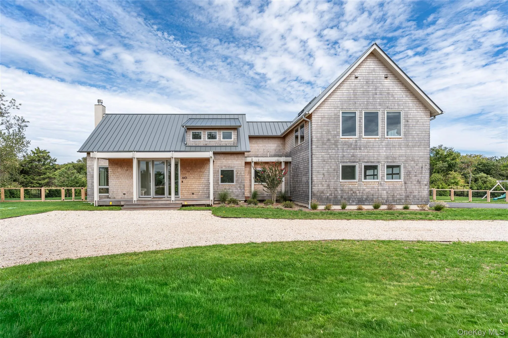 View of front of home featuring a metal roof, a standing seam roof, and a chimney View of front of home featuring a metal roof, a standing seam roof, and a chimney