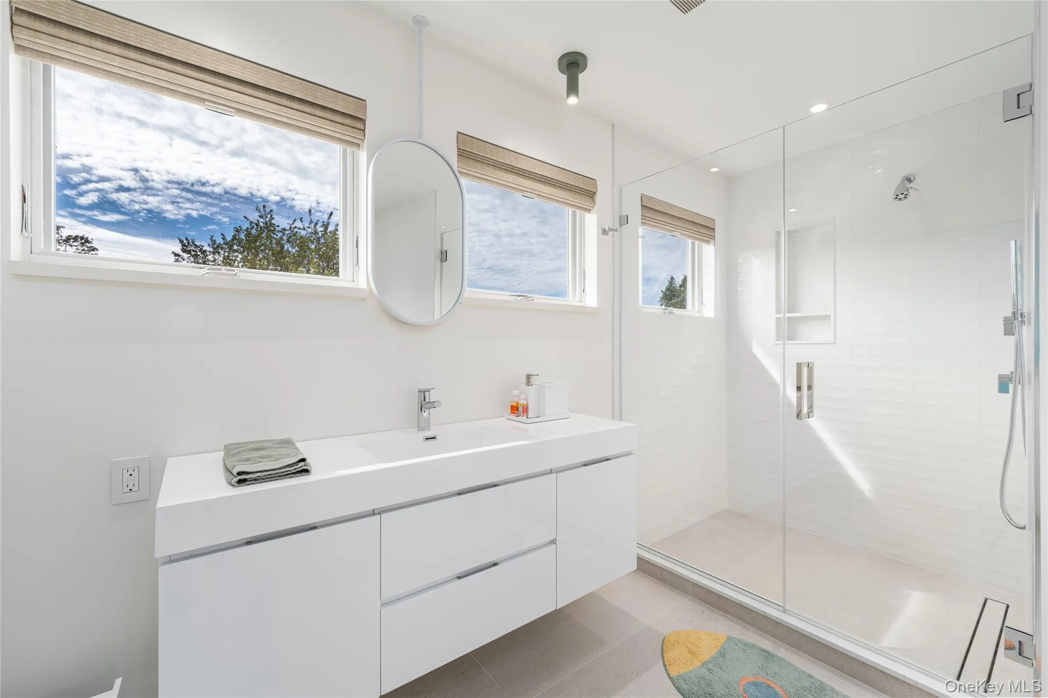 Full bathroom with vanity, a shower stall, recessed lighting, and light tile patterned floors Full bathroom with vanity, a shower stall, recessed lighting, and light tile patterned floors