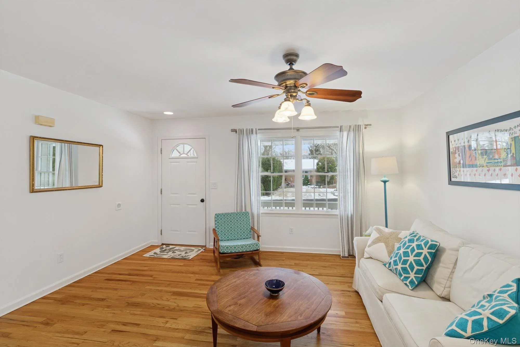 Living area with light wood finished floors, a ceiling fan, and recessed lighting Living area with light wood finished floors, a ceiling fan, and recessed lighting