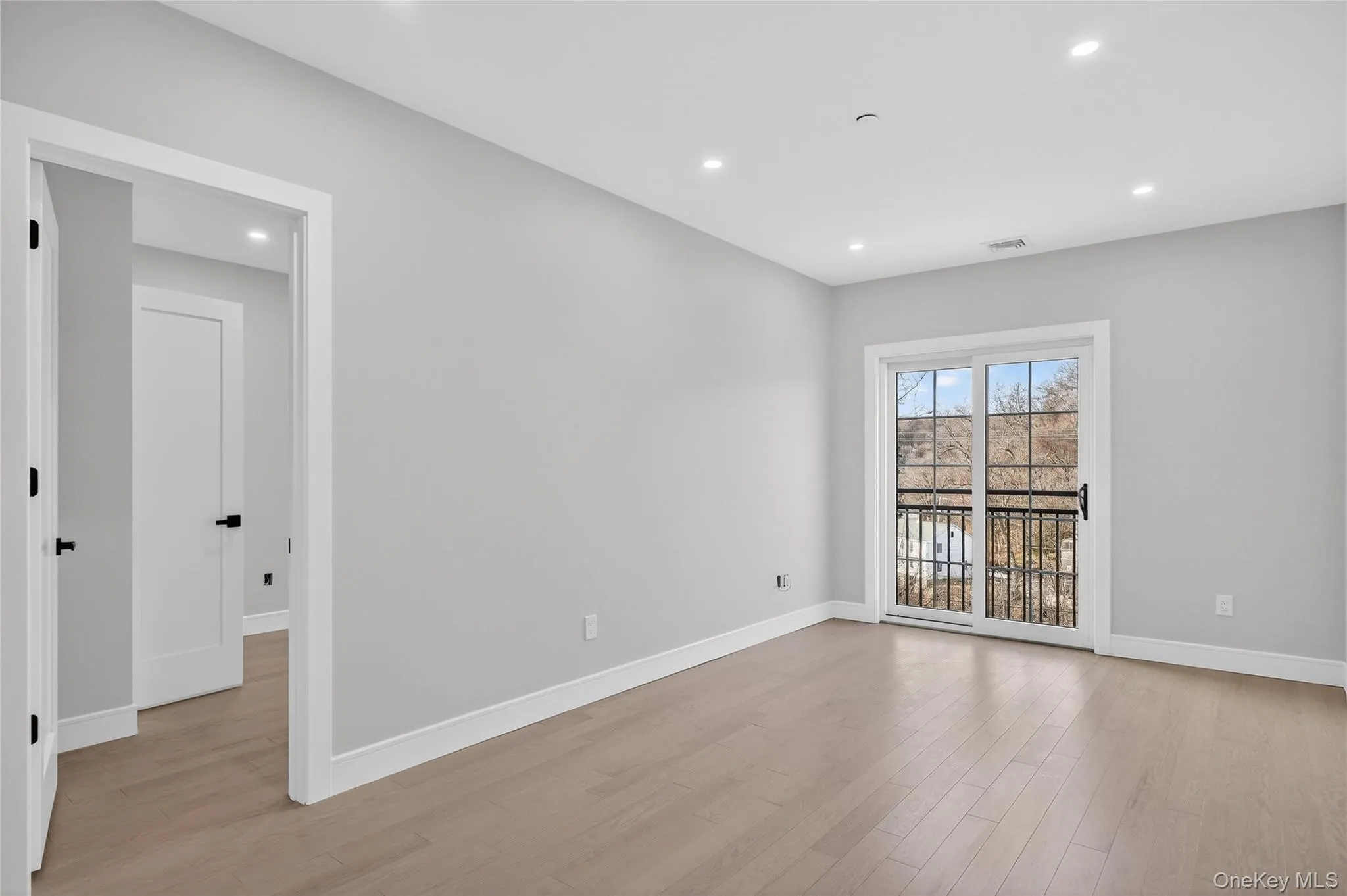 Unfurnished room with light wood finished floors and recessed lighting Unfurnished room with light wood finished floors and recessed lighting