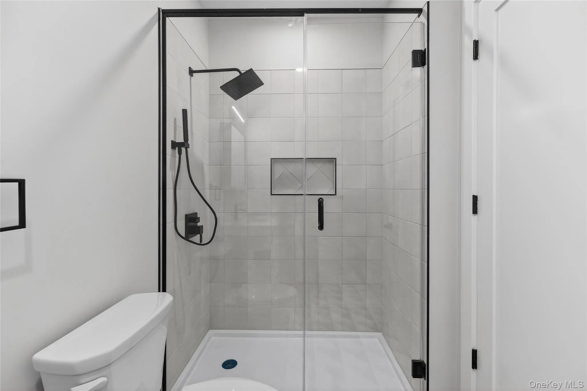 Full bath featuring a stall shower Full bath featuring a stall shower