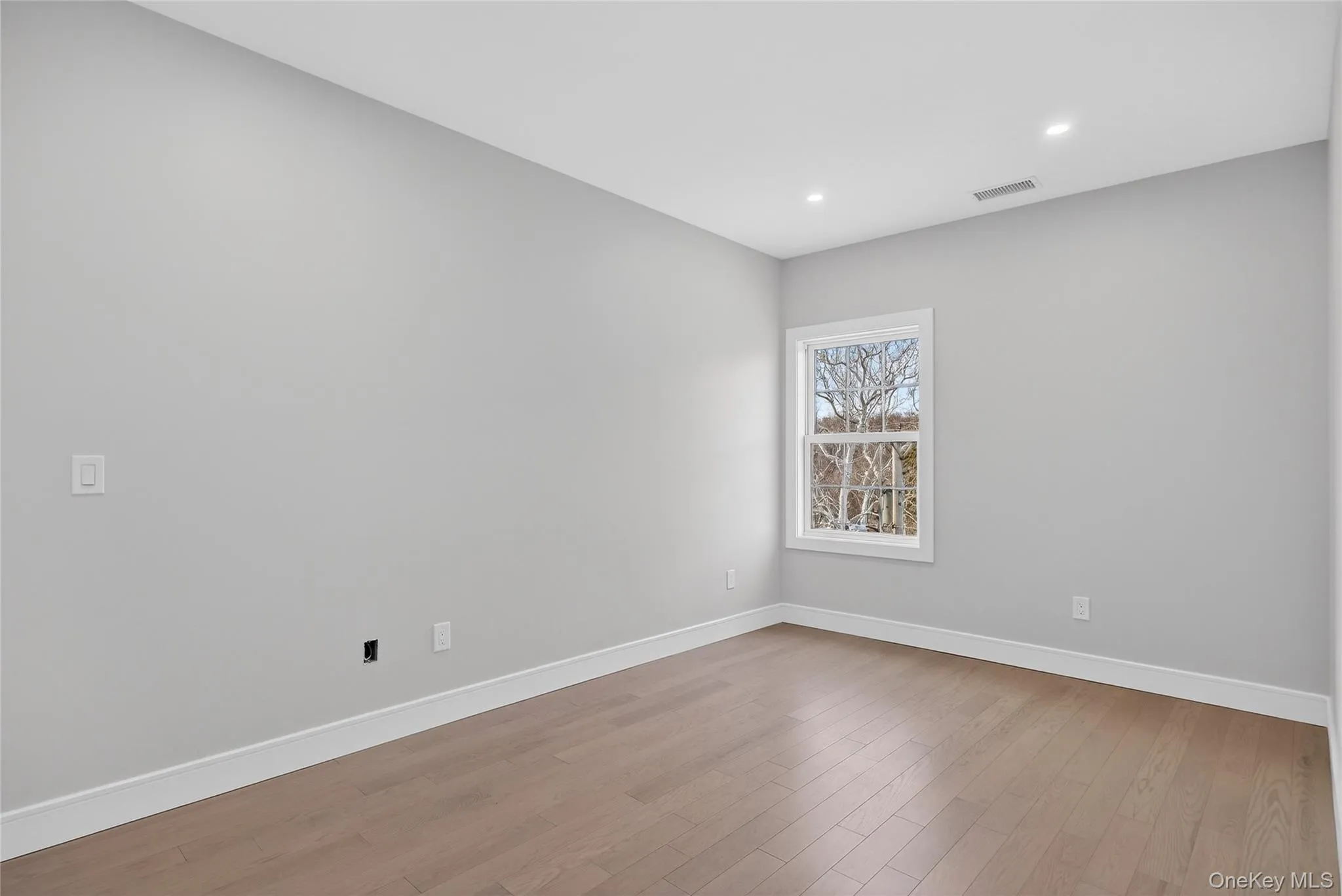 Unfurnished room with light wood-type flooring and recessed lighting Unfurnished room with light wood-type flooring and recessed lighting