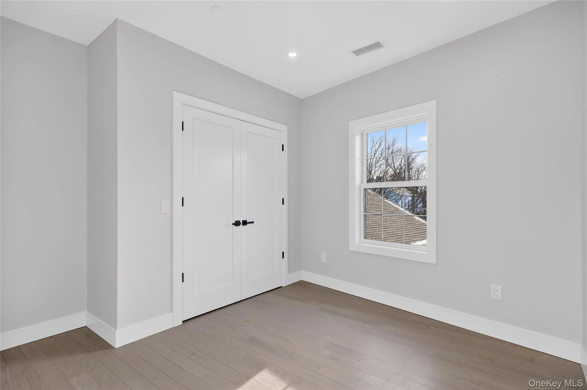 Unfurnished bedroom featuring light wood-type flooring, a closet, and recessed lighting Unfurnished bedroom featuring light wood-type flooring, a closet, and recessed lighting