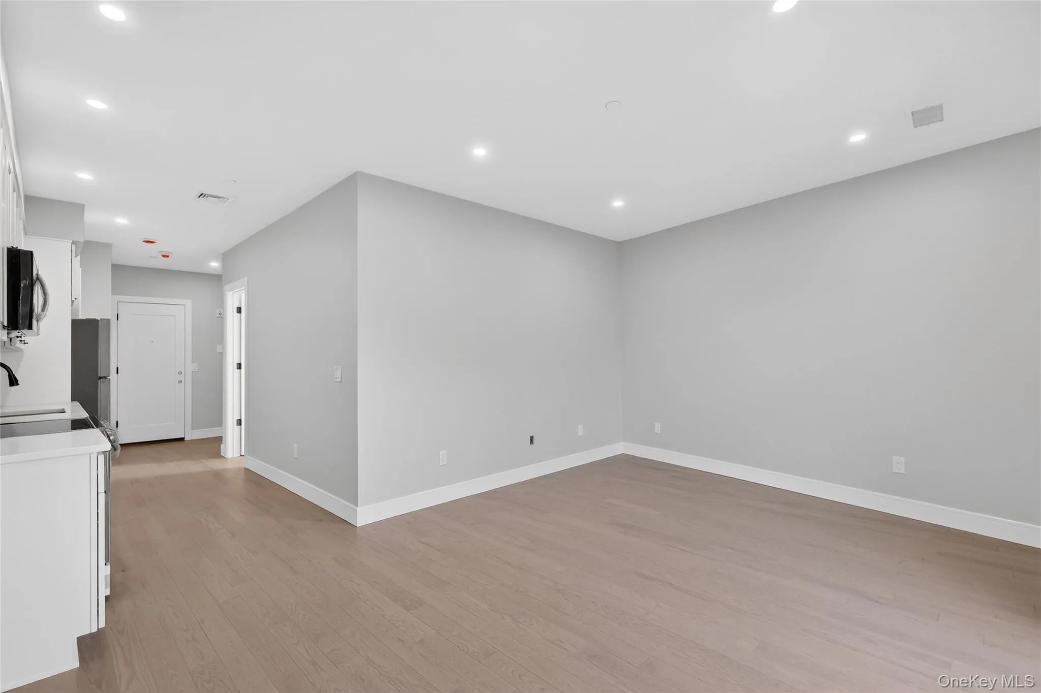 Empty room featuring light wood-style floors and recessed lighting Empty room featuring light wood-style floors and recessed lighting