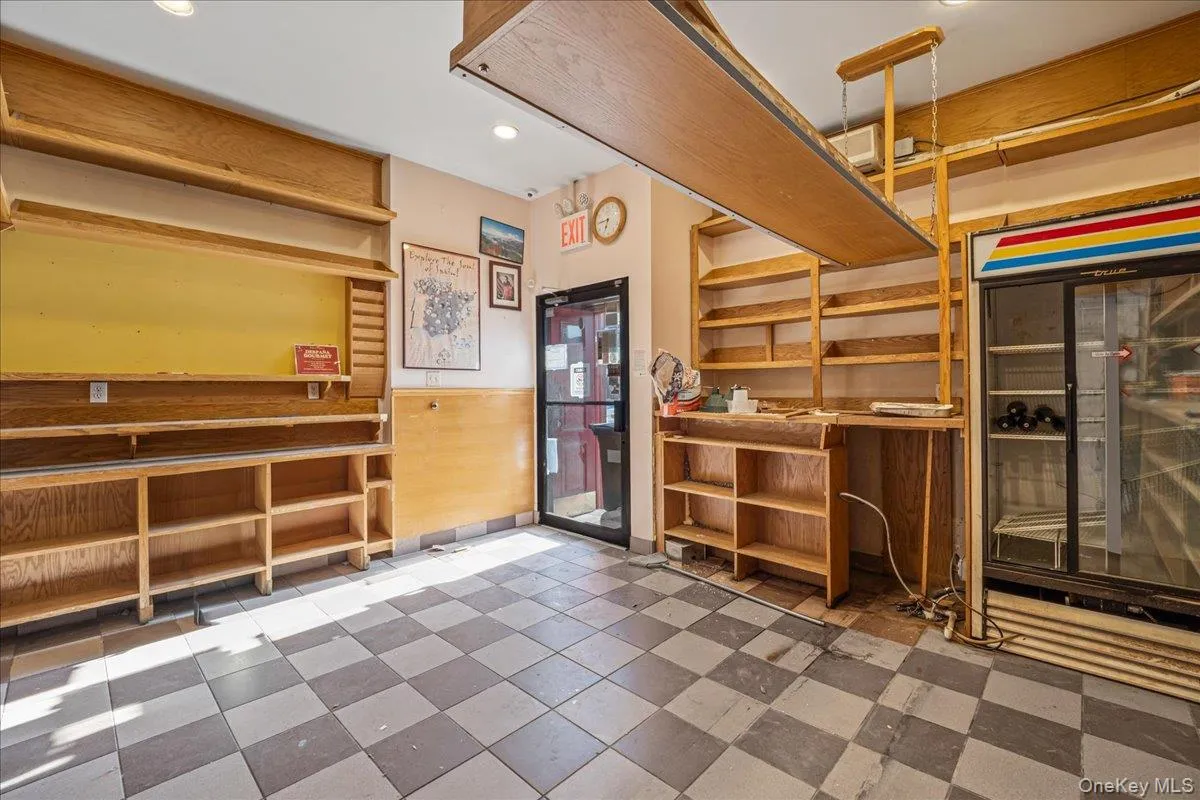 Misc room with tile patterned floors, wainscoting, recessed lighting, and wood walls Misc room with tile patterned floors, wainscoting, recessed lighting, and wood walls