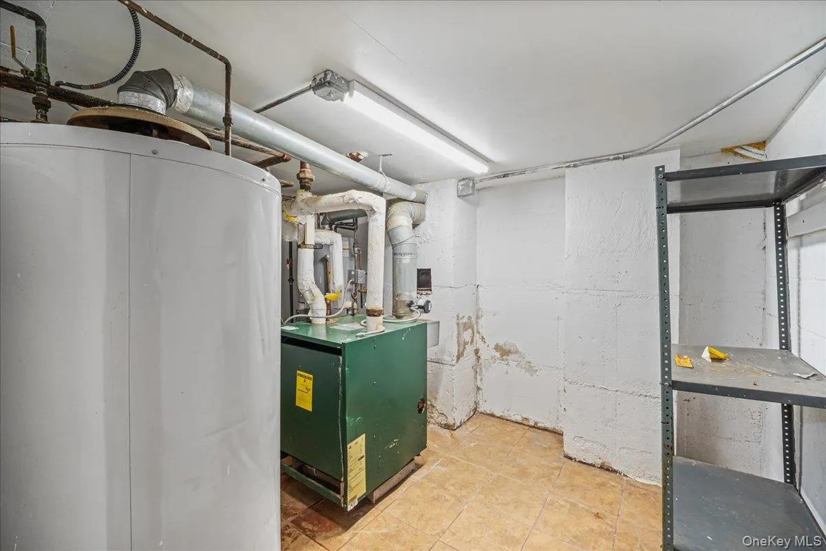 Utility room featuring water heater Utility room featuring water heater