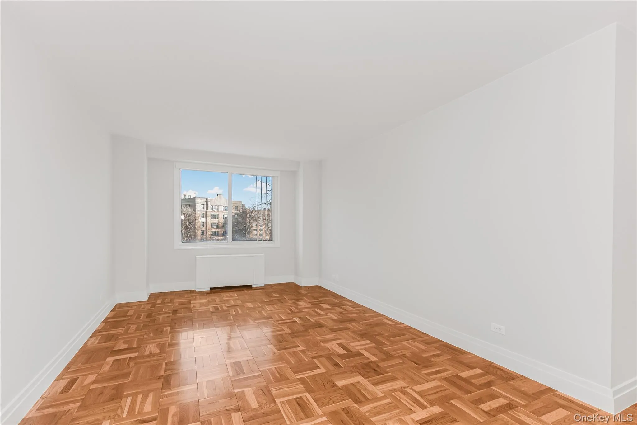 Empty room with baseboards and radiator heating unit Empty room with baseboards and radiator heating unit