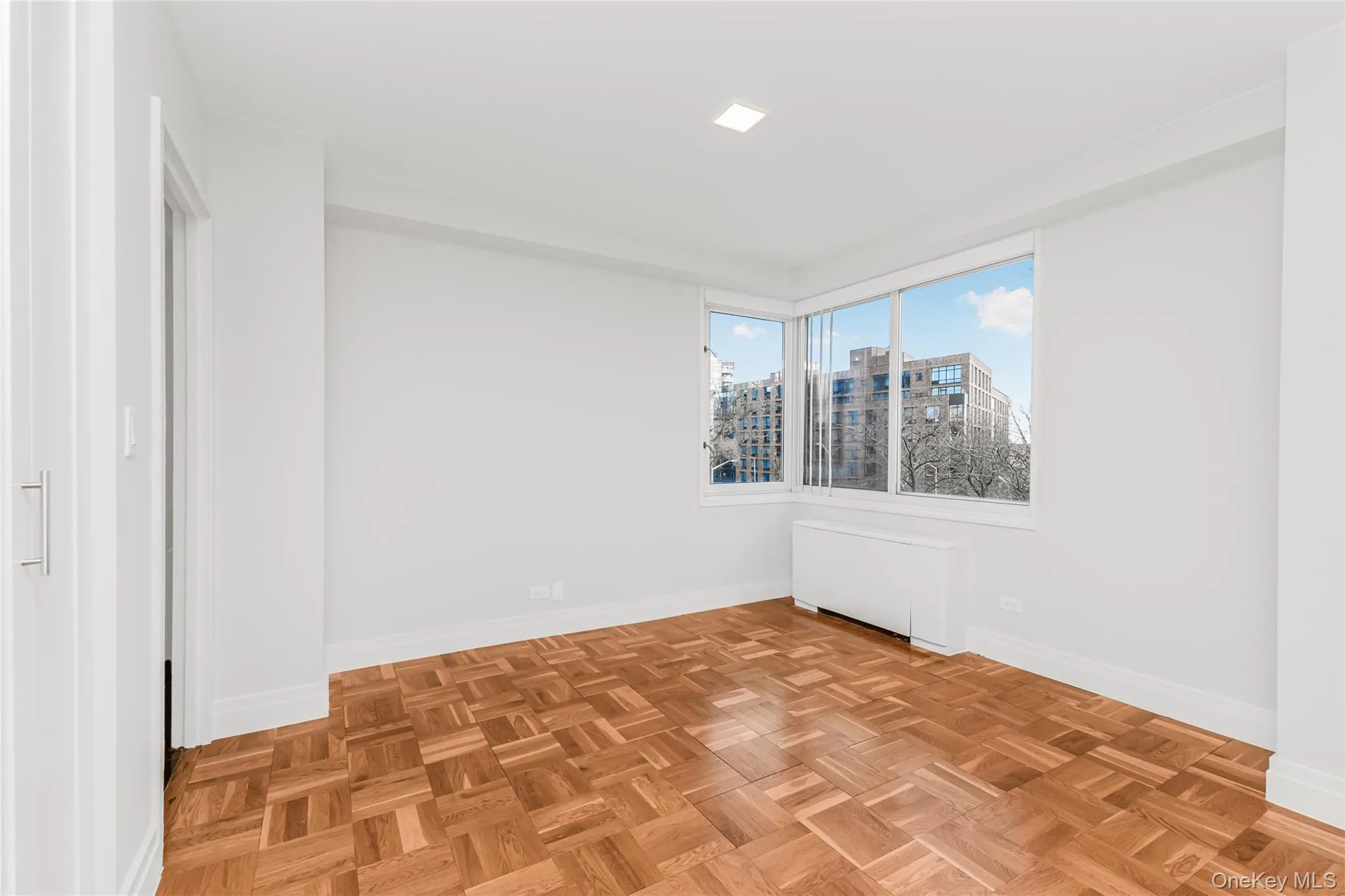 Dining area featuring radiator and a view of city Dining area featuring radiator and a view of city