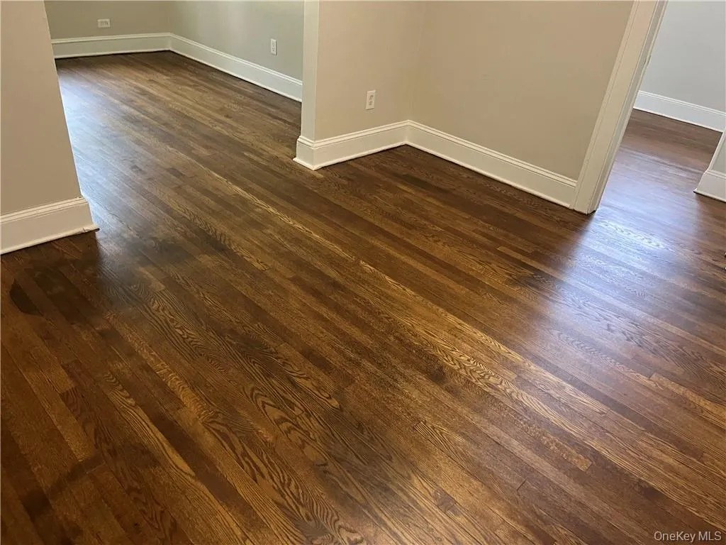 Empty room with dark wood-type flooring Empty room with dark wood-type flooring
