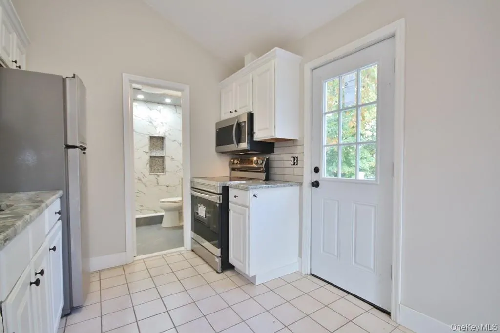 Stainless appliances in Kitchen and door to Deck Stainless appliances in Kitchen and door to Deck