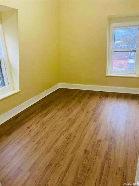 Empty room with hardwood / wood-style flooring Empty room with hardwood / wood-style flooring