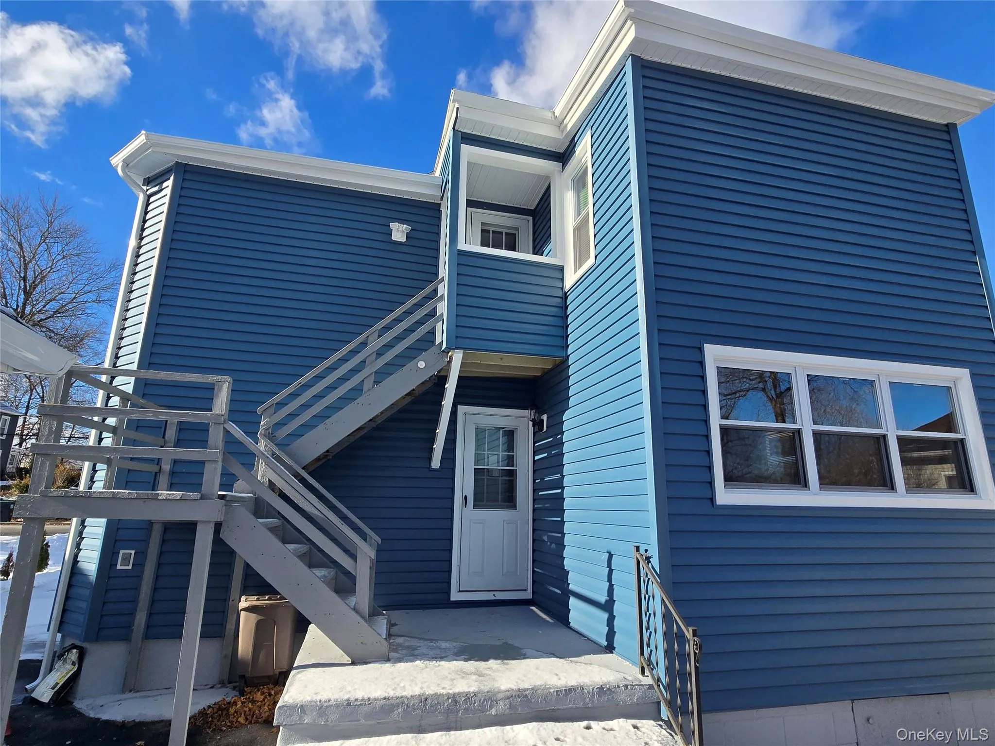 Back of house with stairway and a balcony Back of house with stairway and a balcony