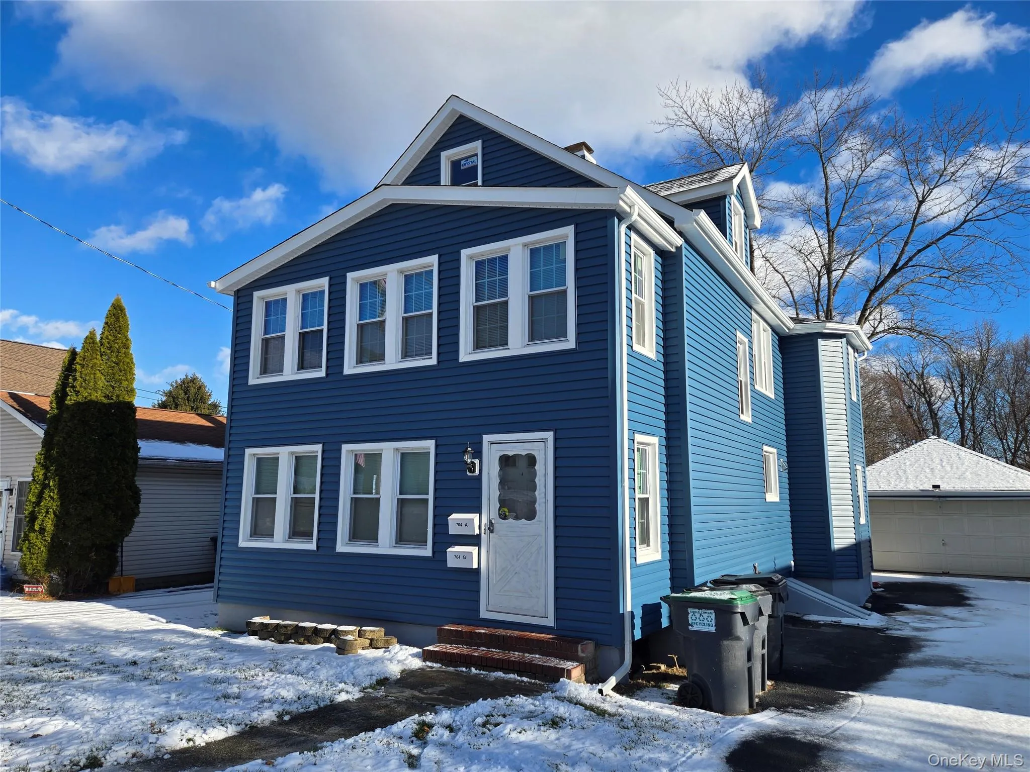 View of front of house featuring an outdoor structure, a detached garage, and entry steps View of front of house featuring an outdoor structure, a detached garage, and entry steps