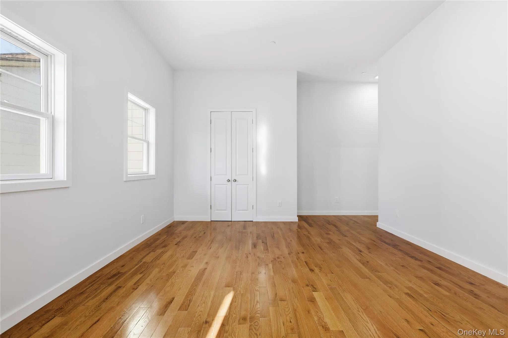 Living Room with hardwood floors and a closet Living Room with hardwood floors and a closet