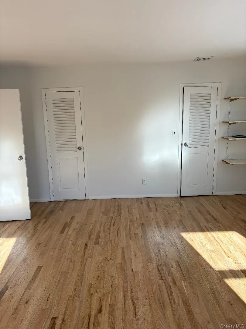 Empty room featuring light wood-style flooring and baseboards Empty room featuring light wood-style flooring and baseboards