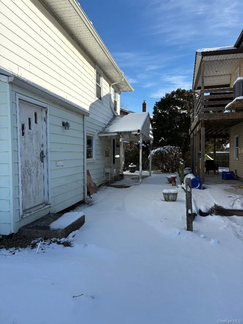 Snowy yard with a patio Snowy yard with a patio