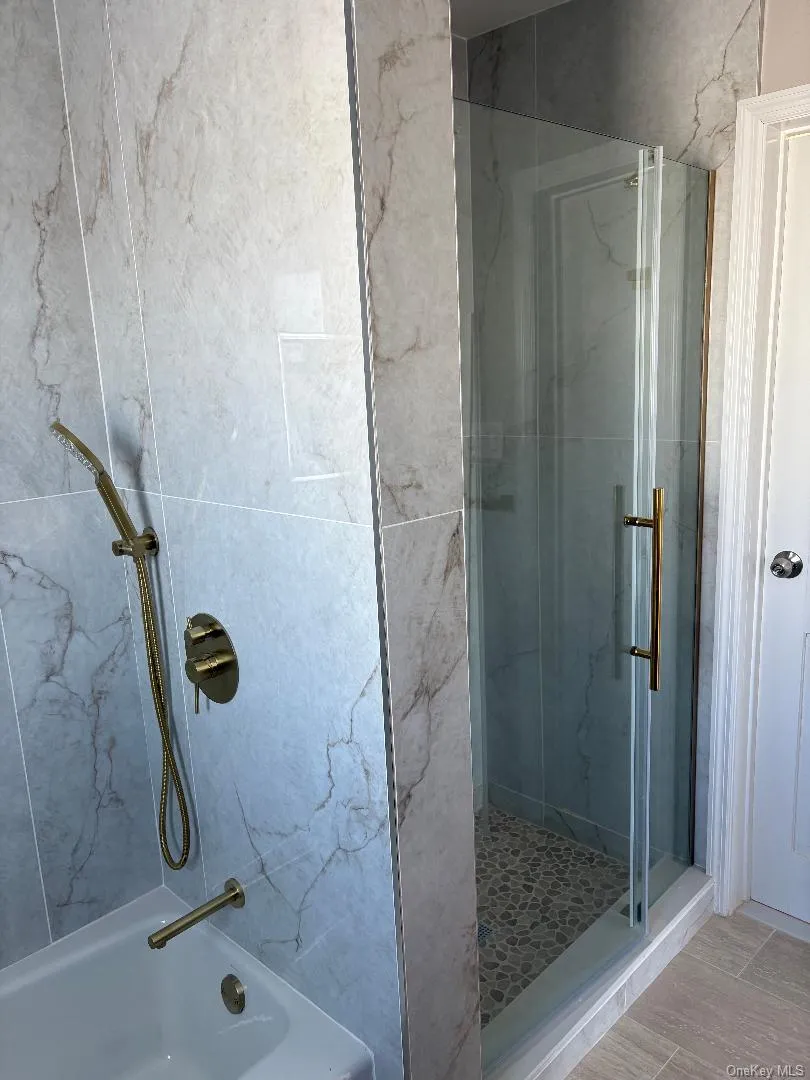 Bathroom featuring combined bath / shower with glass door Bathroom featuring combined bath / shower with glass door