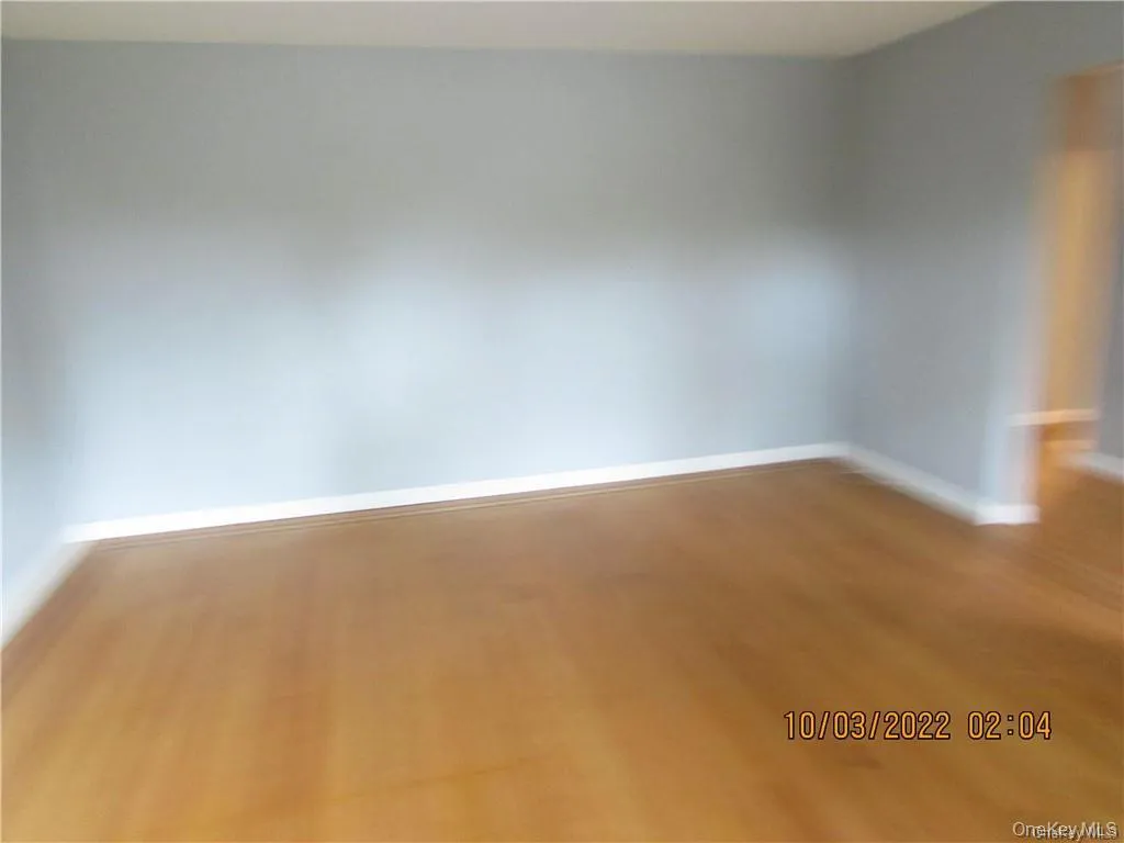 Spare room with baseboards and wood finished floors Spare room with baseboards and wood finished floors