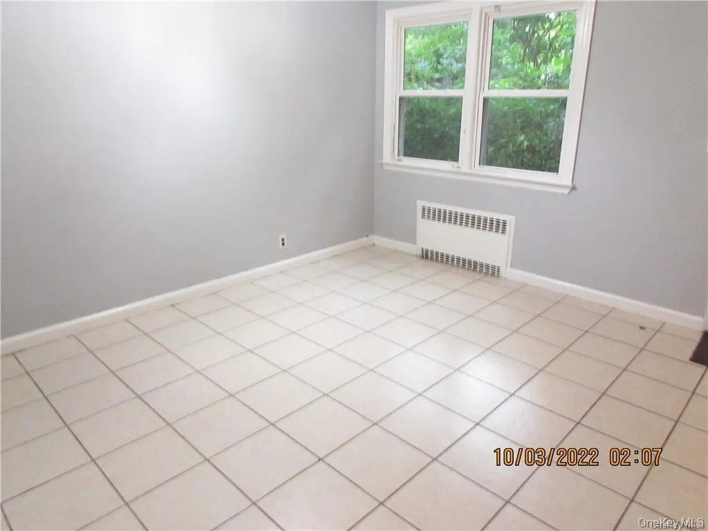 Spare room with radiator and baseboards Spare room with radiator and baseboards